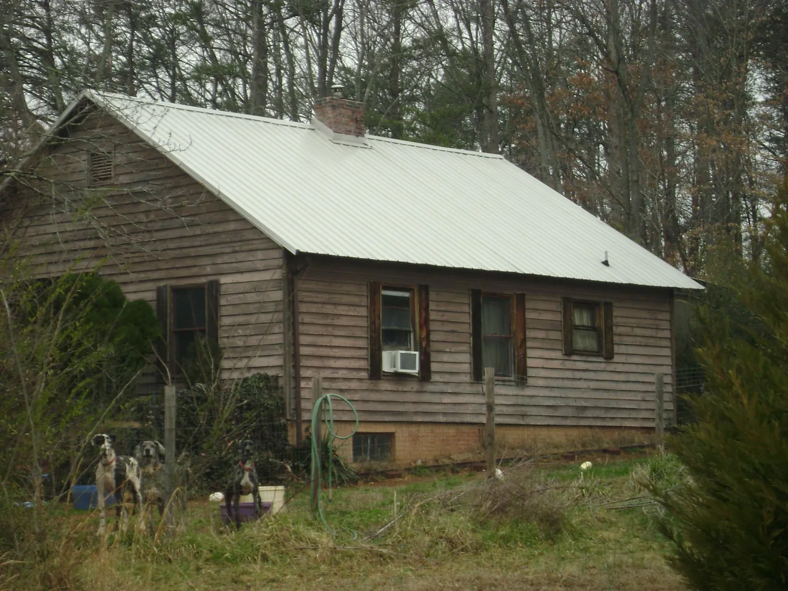 White metal roof on an old wood sided farmhouse in Warsaw